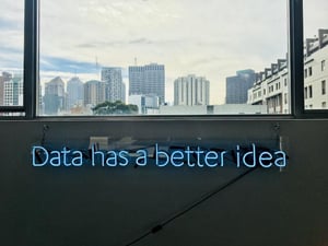 Une enseigne au néon bleu affiche la phrase 